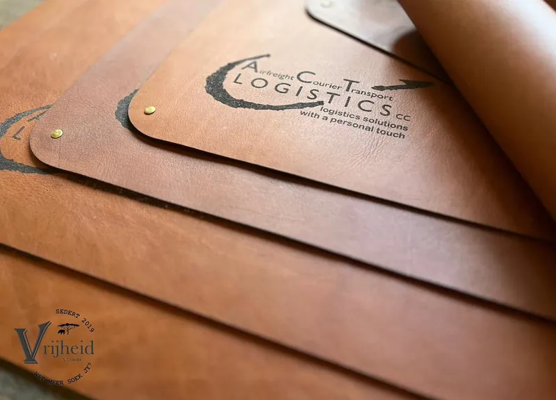 Leather deskpads engraved with a logistics company logo