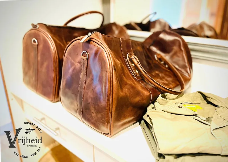 Two handcrafted Vrijheid leather weekender bags on a shelf