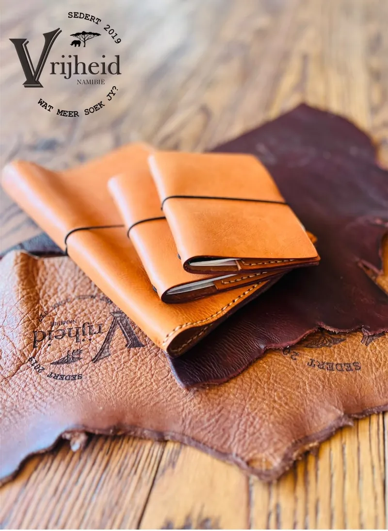Hand-cut tan leather pieces resting on a natural leather hide